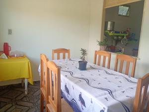 a dining room with a table with a potted plant on it at Pousada kurasi alter 02 in Santarém