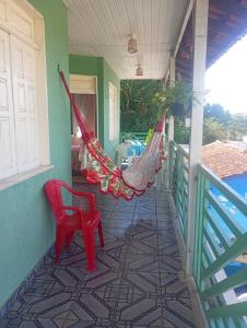 a porch with a hammock on a house at Pousada kurasi alter 02 in Santarém