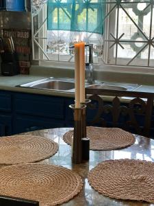 a candle sitting on a table in a kitchen at Elite stays in Santa Cruz