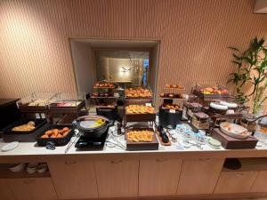 a buffet with many different types of food on a table at Palazzo Cortesi Boutique Hotel in Macerata