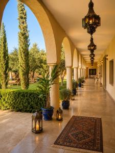 a hallway of a resort with potted plants and lights at Dar Benyahya in Aït Zat