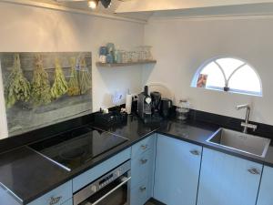 a kitchen with a sink and a counter top at Gastenverblijf 't Oelengoor in Sinderen