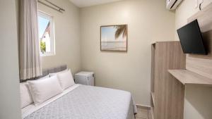 a bedroom with a bed and a television in it at Pousada Estrela Dourada in João Pessoa