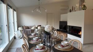 a dining room with a table with cups and chairs at Villa Lydia Lapland - Private Sauna & Aurora View in Rovaniemi +24 photos