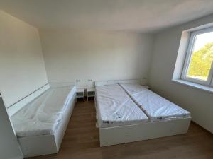 a room with two beds and a window at Hakro Jevisovka in Jevišovka