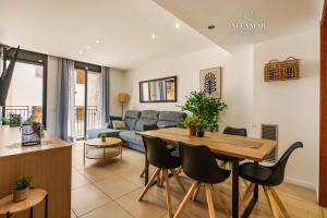 a living room with a table and a couch at Hanami Suite in Lloret de Mar
