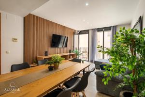 a living room with a wooden table and chairs at Hanami Suite in Lloret de Mar