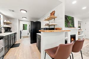 a kitchen with a black refrigerator and a counter at Gravity Getaway in Bella Vista