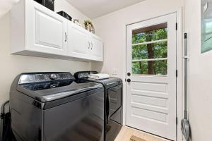 a kitchen with a washer and dryer next to a door at Gravity Getaway in Bella Vista +19 photos