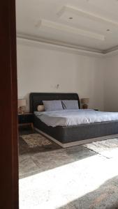 a bedroom with a large bed in a room at Villas HouN Assinie in Mafia +3 photos