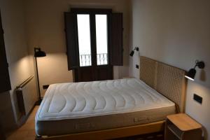 a bed in a room with a window at Can Hortafa in Tortellá