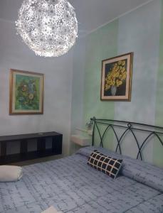 a bedroom with a bed and two pictures on the wall at Villa Santa Chiara in Loreto