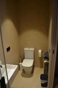 a bathroom with a toilet and a bath tub at Can Hortafa in Tortellá