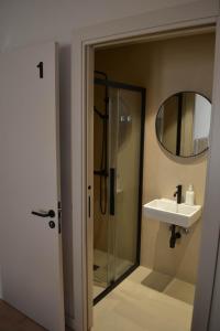 a bathroom with a shower and a sink and a mirror at Can Hortafa in Tortellá