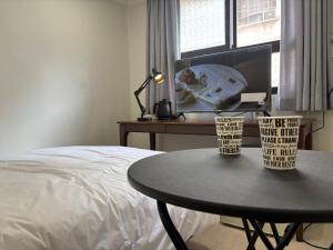 a bedroom with a table next to a bed and a desk at Stay brick in Seoul