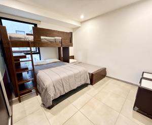 a bedroom with a bunk bed and a large window at Departamento de lujo en Col Americana con alberca in Guadalajara