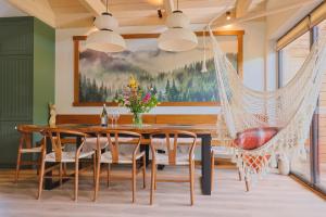 a dining room with a wooden table and a hammock at Furdasówka in Szczawnica
