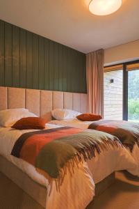 a bedroom with two beds and a large window at Furdasówka in Szczawnica