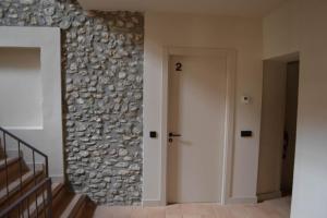 a hallway with a stone wall and a door at Can Hortafa in Tortellá +55 photos