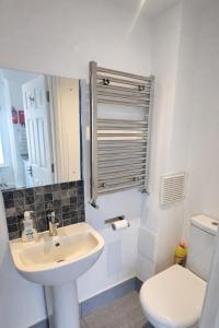 a bathroom with a sink and a toilet at Studio Flat London in The Hyde