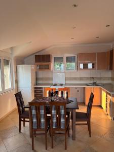 a kitchen with a table and chairs in it at Vila Denda Herceg Novi in Herceg-Novi