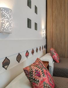 a hotel room with a bed and a chair at La Estrella de Tarifa in Tarifa