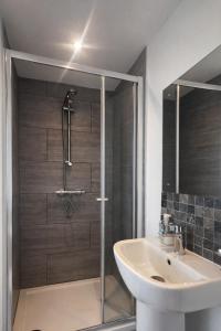 a bathroom with a shower and a sink at Studio Flat London in The Hyde