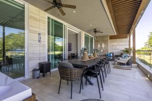a dining room with a table and chairs on a patio at 3 Bedroom apt with jacuzzi in Baru in Cartagena de Indias