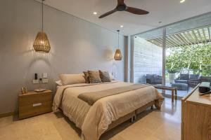 a bedroom with a bed and a ceiling fan at 3 Bedroom apt with jacuzzi in Baru in Cartagena de Indias