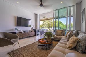 a living room with a couch and a tv at 3 Bedroom apt with jacuzzi in Baru in Cartagena de Indias
