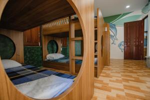 a room with two bunk beds and a mirror at 4be Cá Heo in Cầu Sông Kinh