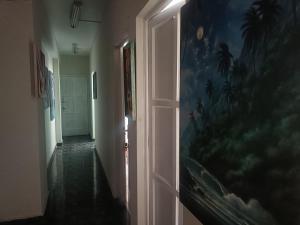 a hallway with an open door with a painting on the wall at Nazareth in Lima
