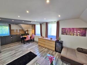 a living room with a couch and a table at Stay4U Veszprém in Veszprém +3 photos