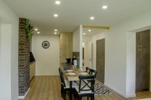 a kitchen and dining room with a table and chairs at Manor in Stará Lesná
