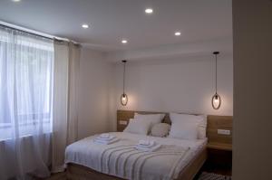 a bedroom with a bed with two lights above it at Manor in Stará Lesná
