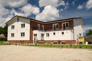 a large white building with a brick at Manor in Stará Lesná