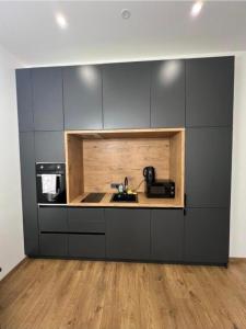 a kitchen with a sink and a microwave at Modern apartment in Klaipėda