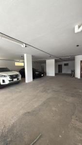 an empty garage with two cars parked in it at شقق وهل in Dammam