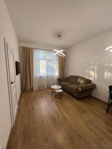 a living room with a couch and a table at Modern apartment in Klaipėda