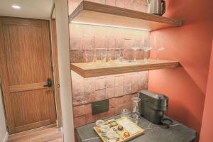 a kitchen with a counter with glasses on a shelf at Casa México in Mexico City +49 photos