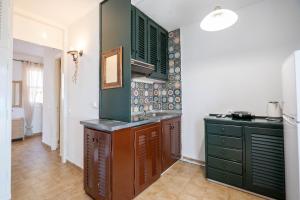 a kitchen with green cabinets and a sink at Corfu Glyfada Beach Apartment 24 in Glyfada