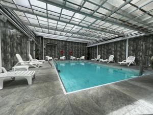 a large swimming pool with chairs at Ker San Telmo Hotel in Buenos Aires