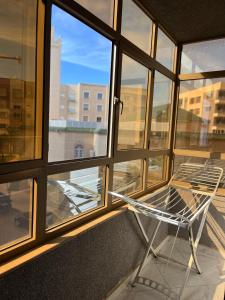a chair sitting in front of a window at Zaio in Nador