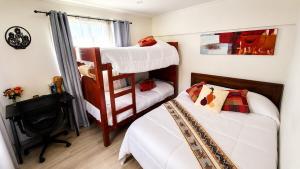a bedroom with two bunk beds and a desk at Milagro Andino in Arica +11 photos