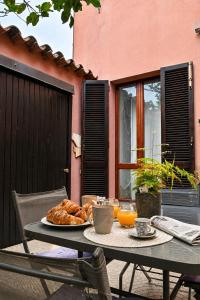 a table with a plate of food on a patio at CASA MILENA in Settimo San Pietro