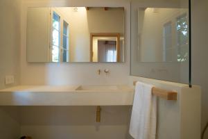 a bathroom with a white sink and a mirror at Hotel Cas Ferrer Monjo in Ciutadella