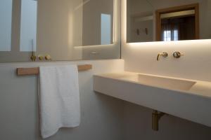 a bathroom with a sink and a mirror and a towel at Hotel Cas Ferrer Monjo in Ciutadella