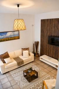 a living room with a couch and a coffee table at CASA MILENA in Settimo San Pietro