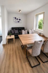 a living room with a wooden table and chairs at Apartment Kaiblingblick in Haus im Ennstal