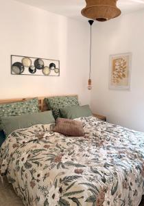 a bedroom with a bed with a floral comforter at Naša Priča Silver Lake in Veliko Gradište